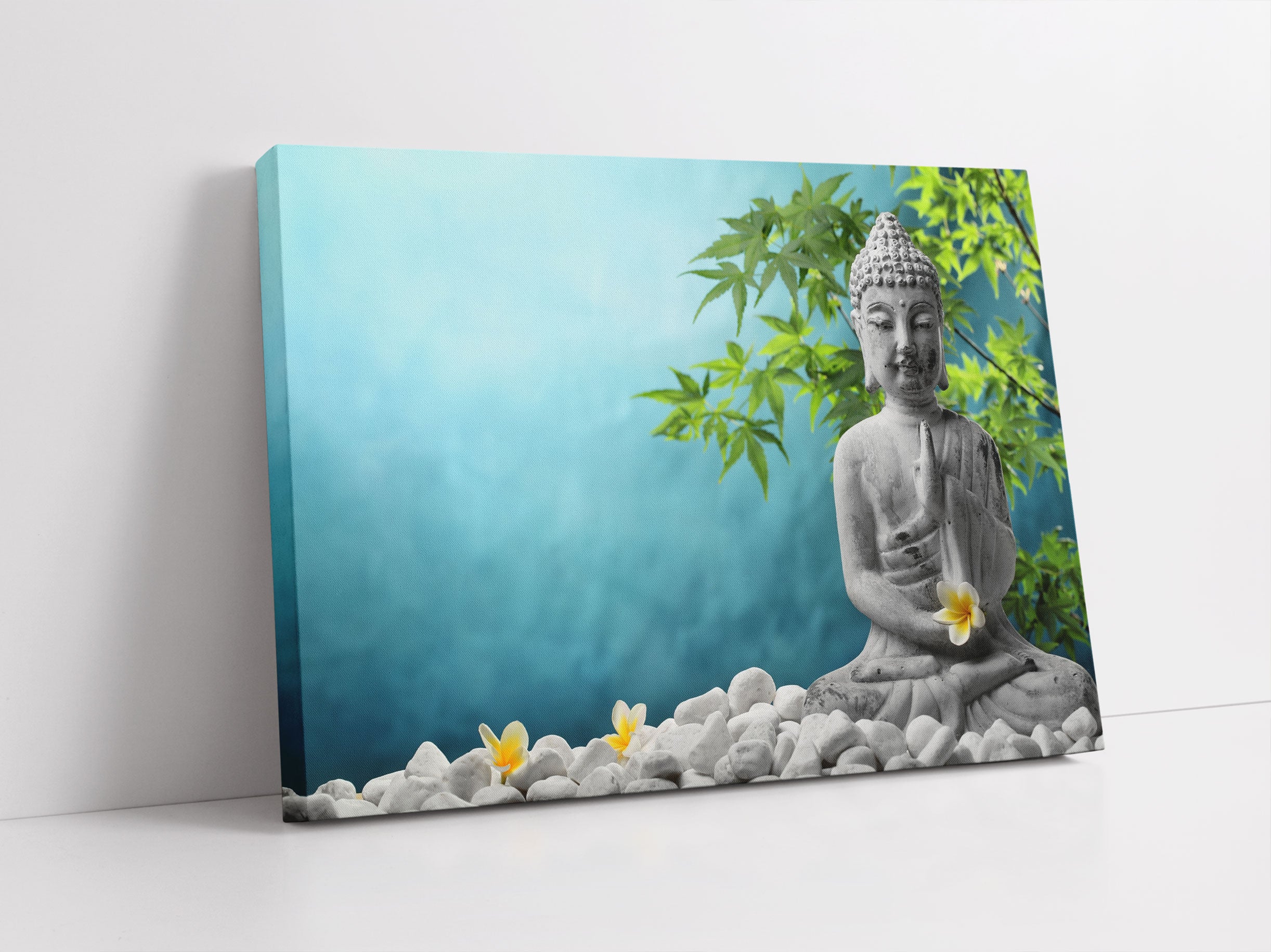 Buddha auf Steinen mit Monoi Blüte Leinwandbild Studio