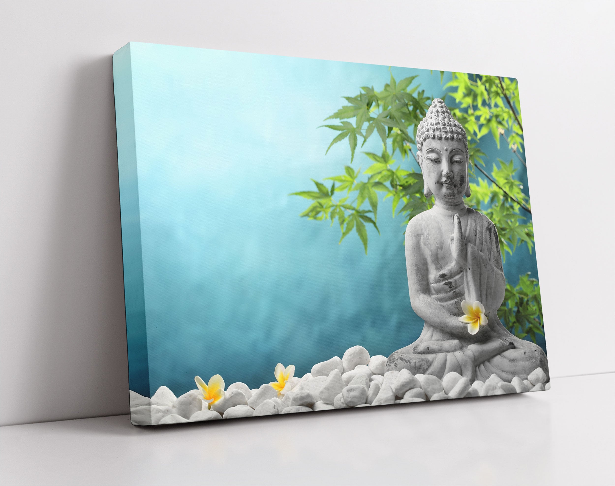 Buddha auf Steinen mit Monoi Blüte - Leinwandbild