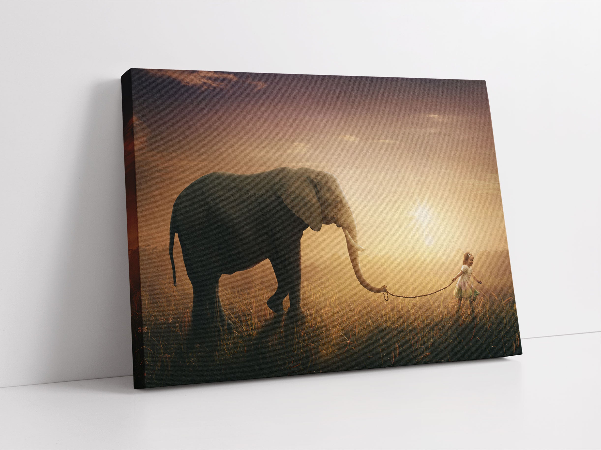 Kind und Elefant bei Sonnenuntergang Leinwandbild Studio