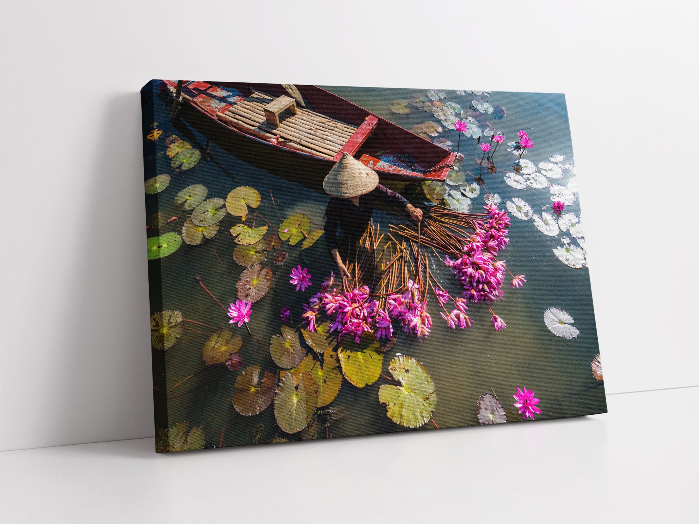 Wasserlilienernte mit Boot in Vietnam Leinwandbild Studio